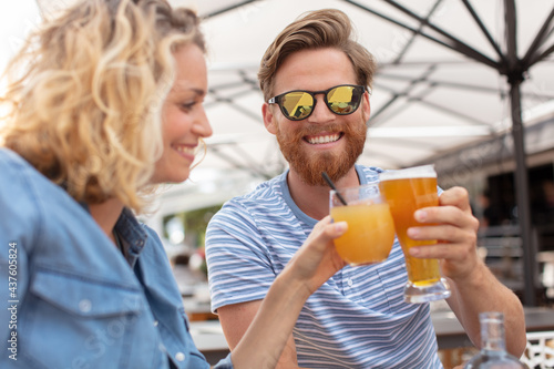 romantic couple drinking beer with artistic lens flare