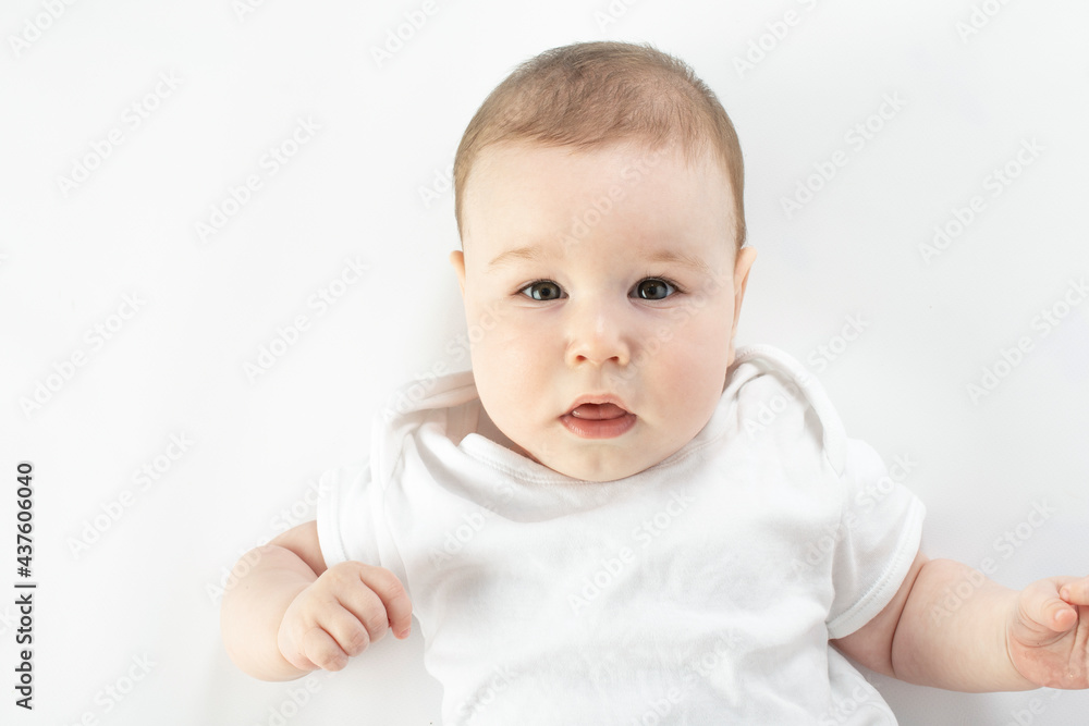 baby looks at the camera with a neutral face