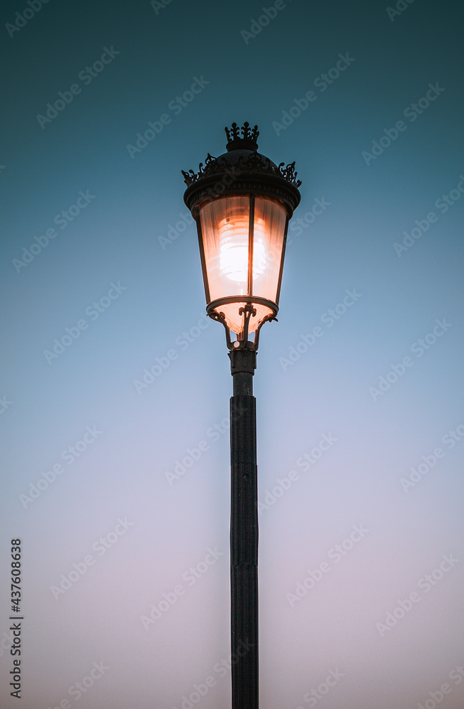 old lamp on blue sky background