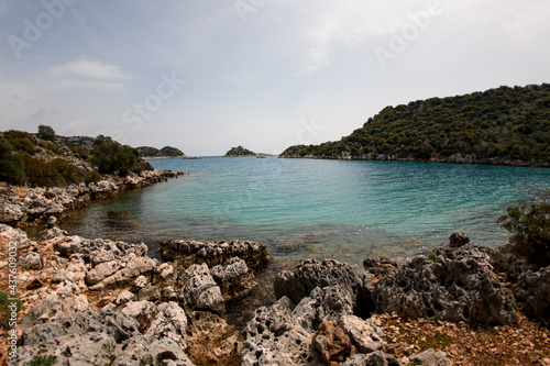 View of turquoise water of the sea and rocky coast and blue sky © fesenko
