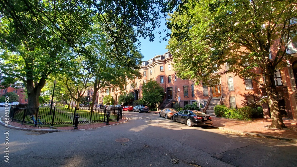 alley in a city with red buildings, cars and a park (Worcester st)