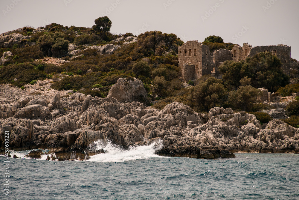 view to island with the ruins of the old building of ancient city view to island with the ruins of the old building of ancient city