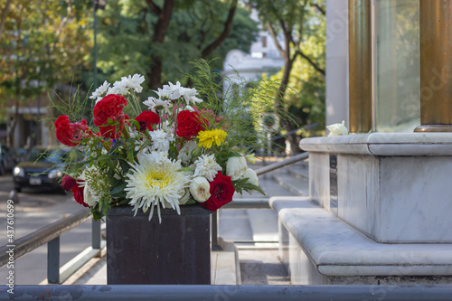 Flower arrangement with red, white and yellow flowers.