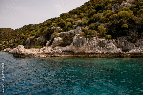 magnificent view of rocks with green trees and clear turquoise water of the Mediterranean Sea © fesenko