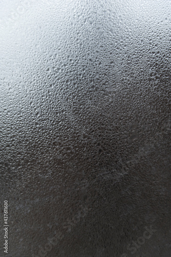 Window glass with water drops. Abstract gray background with drops and stains. Vertical frame