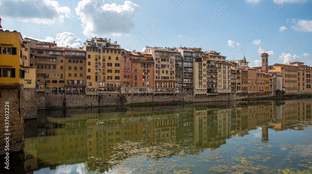 Buidings at Ponte Vecchio landmark reflected on arno river. Florence, Tuscany Italy.