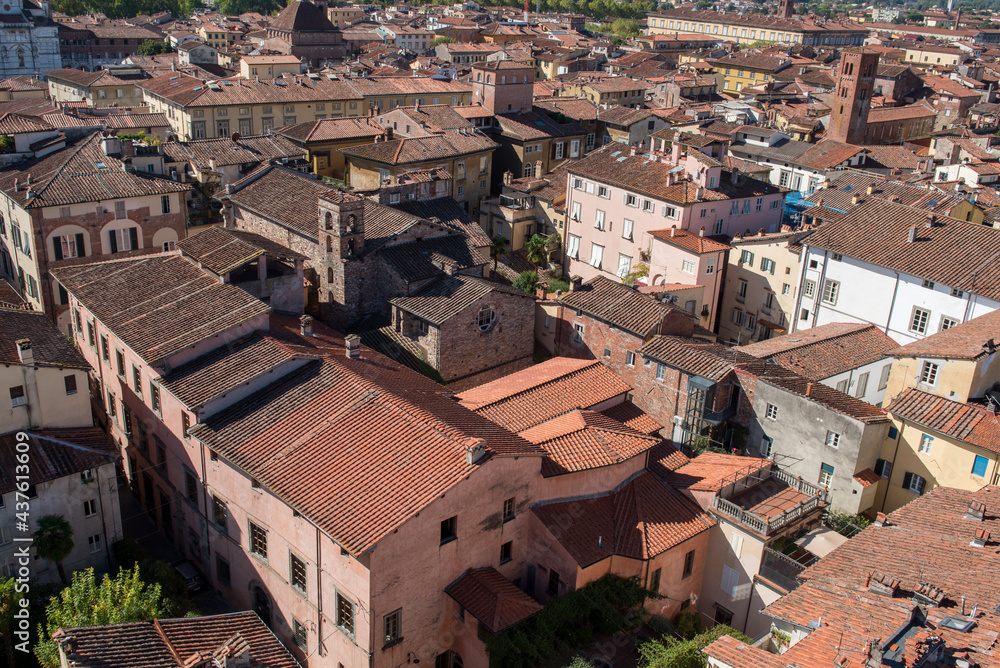 Cityscape with rooftops of Lucca town from Torre Ginigi tower. Tuscany central Italy