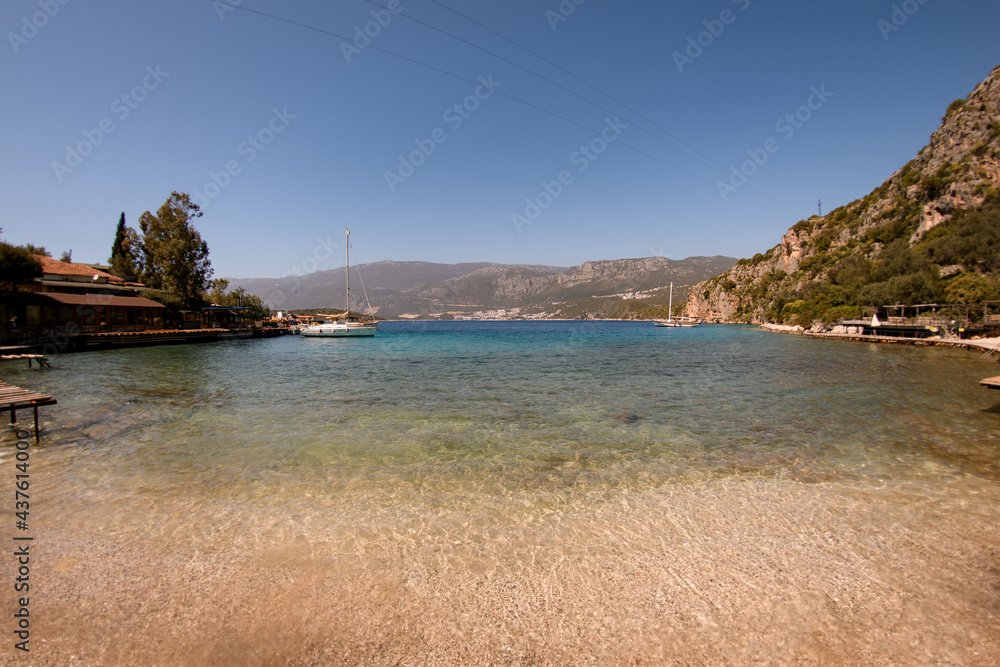 Obraz premium great view from shore to clear transparent turquoise water of sea bay and mountains landscape