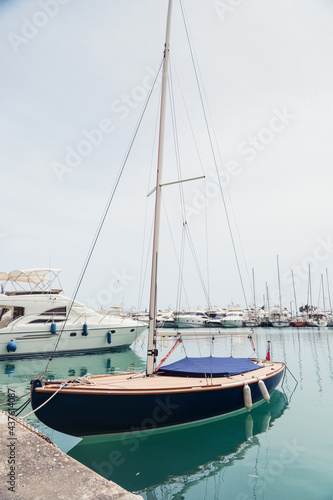 Yacht parking in harbor. White sailing yachts at the pier. Sea yacht club. Aegean sea. Athens  Greece. Blue sky.