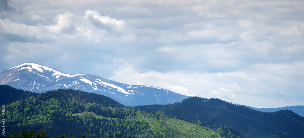 Panorama of the Carpathian mountains in the snow on a spring day
