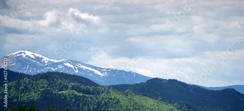 Panorama of the Carpathian mountains in the snow on a spring day