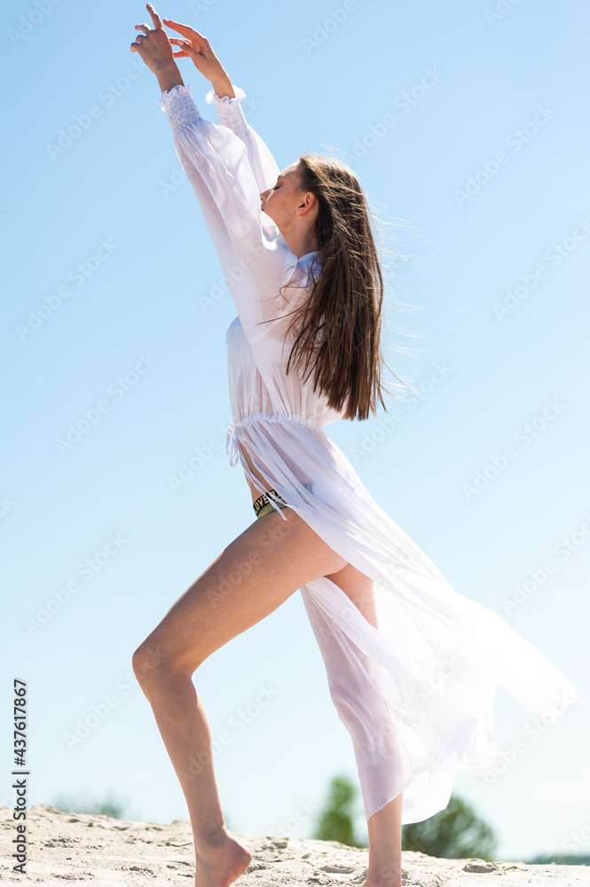 Woman in white on the blue sky background Woman in white on the blue sky background