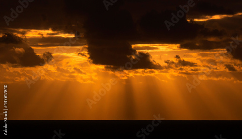 God rays through dark clouds at sunset © Chris Ison