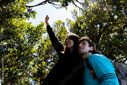 couple on a walk in the mountain and forest looking at the vegetation and landscape on vacation 