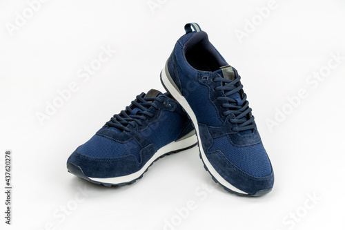 NEW BLUE, CASUAL, FASHIONABLE AND STYLISH PAIR OF SNEAKERS ON WHITE BACKGROUND. SPORTSWEAR, SHOPPING AND GIFTS CONCEPT.