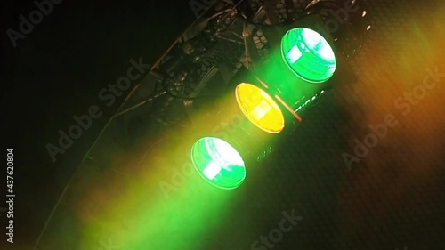 Three classic stage spotlights flash in the fog under the stage ceiling in a loop