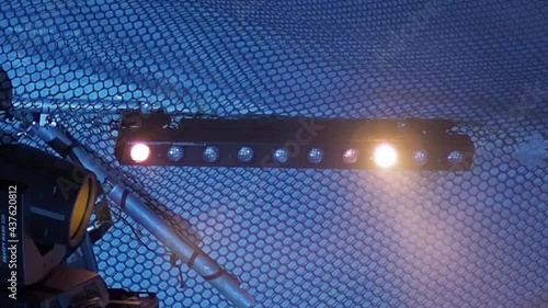 Stage lighting fixture in the form of a row of bulbs flickers in the fog