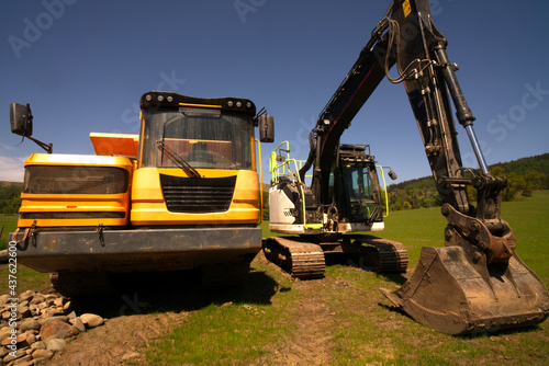 Excavators are heavy construction equipment consisting of a boom  dipper  bucket and cab on a rotating platform known as the  house . The house sits atop an undercarriage with tracks or wheels.