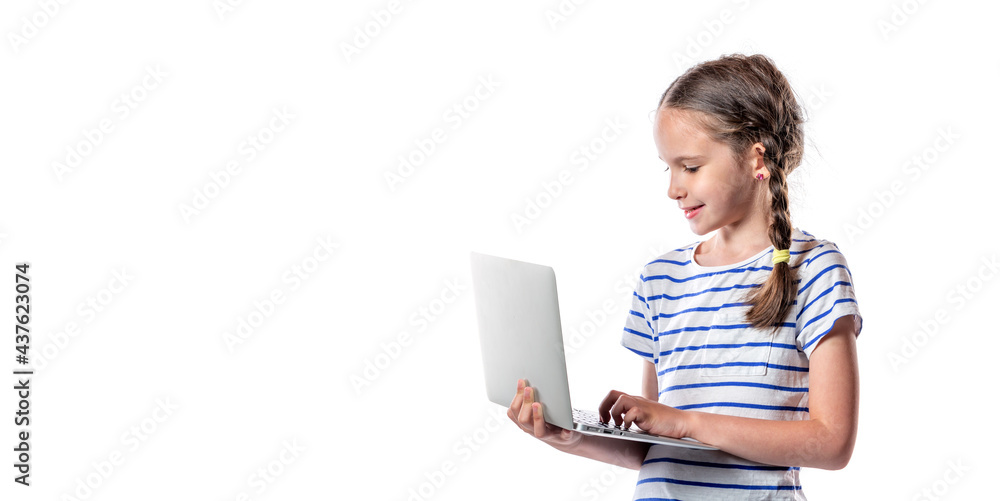 Cute little european girl holding and working with modern silver laptop isolated on white background. Free space Cute little european girl holding and working with modern silver laptop isolated on white background. Free space