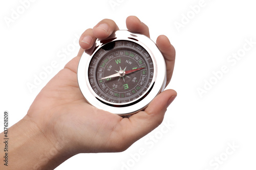 Close up of hand holding magnetic silver metal compass