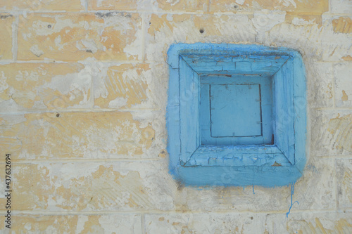 Weathered brick wall and old blue window