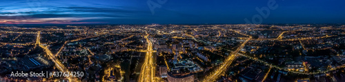 aerial panoramic cityscape with illuminated streets and buildings at night. Minsk, Belarus.