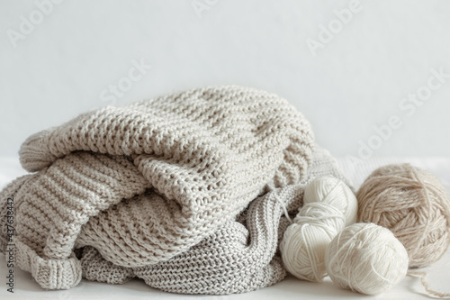 Cozy composition with knitted yarn in pastel colors.