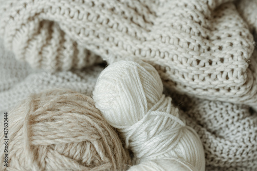 Cozy composition with knitted yarn in pastel colors.