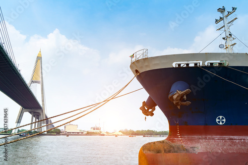 Cargo ships or break-bulk carrier. Logistics and transportation of container with Bhumibol bridge in shipyard,Thailand,with sunlight at port,logistic import export and transport industry.