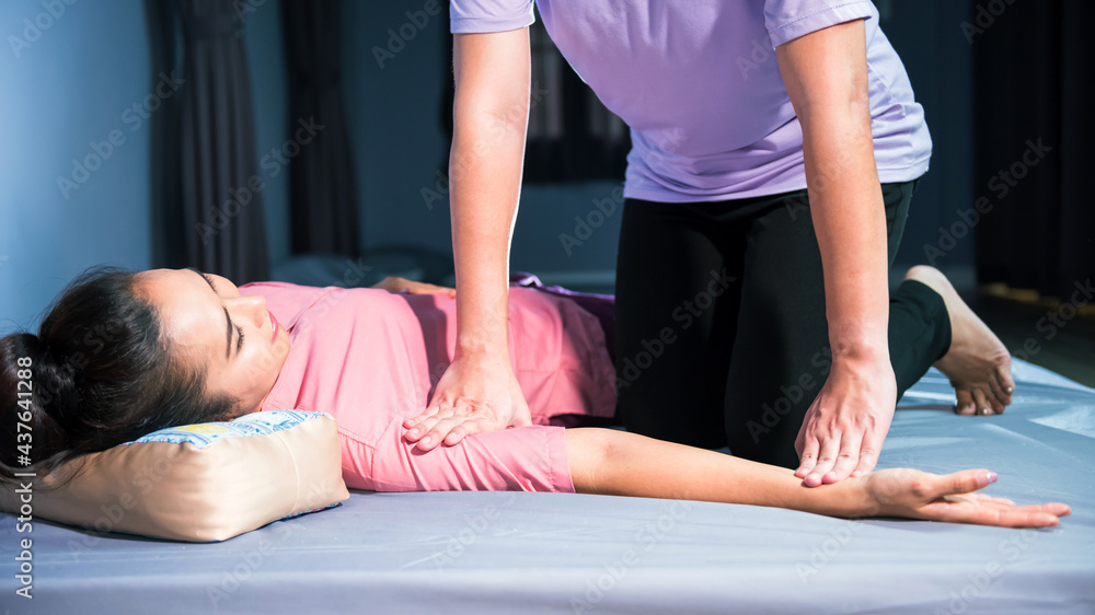 Thai arm massage on bed in spa salon