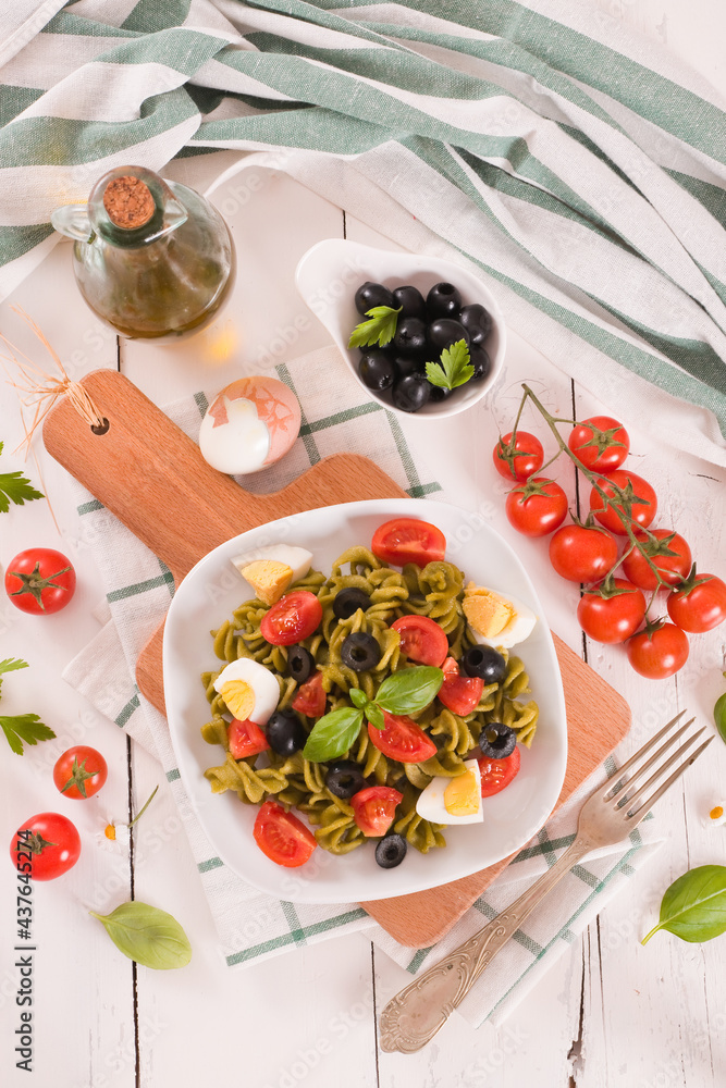 Fusilli pasta with cherry tomatoes, eggs and black olives. Fusilli pasta with cherry tomatoes, eggs and black olives.