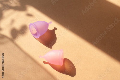 Menstrual cups minimalistic sunny image flat lay top view background with copy space photo