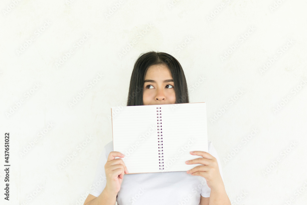Asian teenage woman holding notebook on white background, Asian student education Asian teenage woman holding notebook on white background, Asian student education