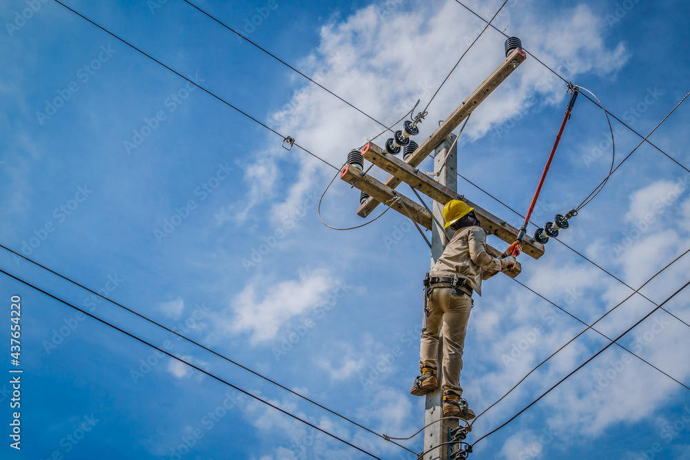 The power lineman use clamp stick (insulated tool) to closing a transformer on energized high-voltage electric power lines. The power lineman must be trained because it is a risky job The power lineman use clamp stick (insulated tool) to closing a transformer on energized high-voltage electric power lines. The power lineman must be trained because it is a risky job