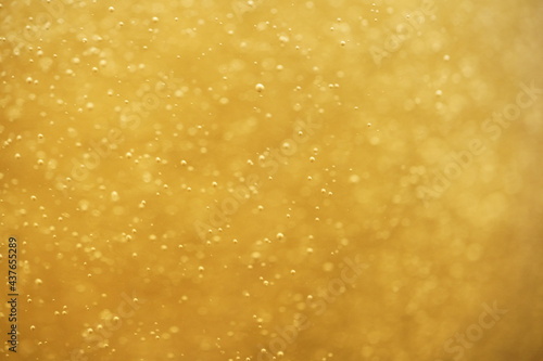Close up motion blur texture of beer bubbles