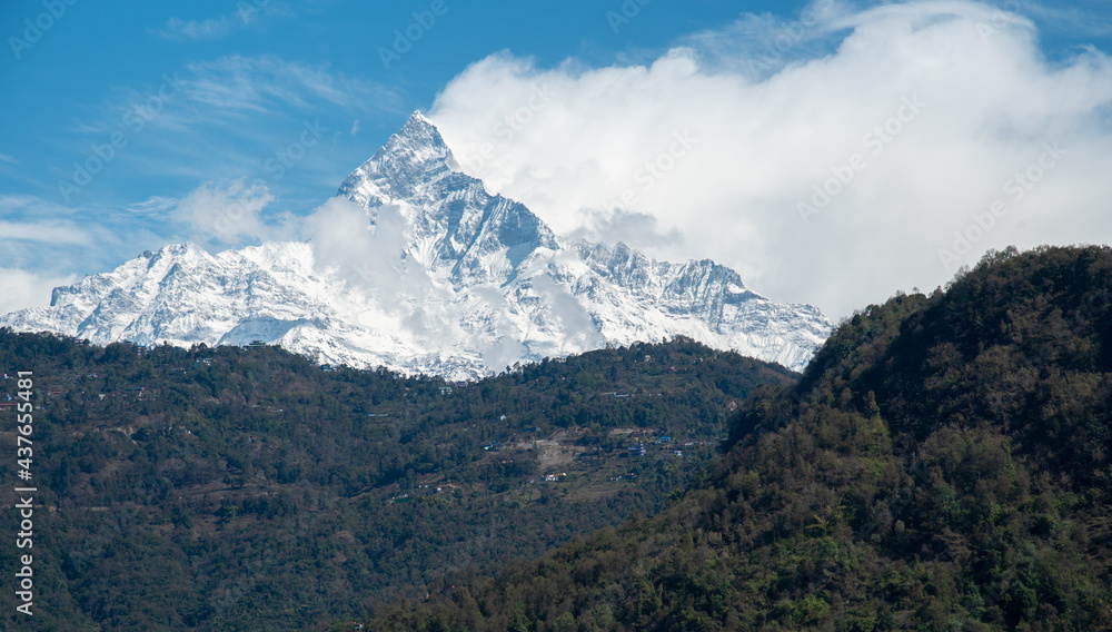 Annapurna massif mountains Himalayas covered in clouds, snow and ice in north central Nepal Asia.