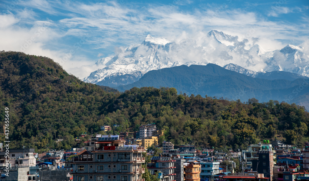 Pokhara cityscape with the Annapurna mountain range covered in snow at central Nepal, Asia