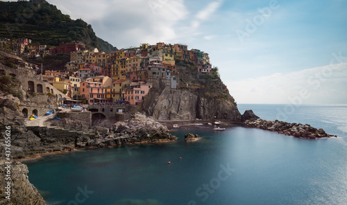 Village of Manarola with colourful houses at the edge of the cliff Riomaggiore, Cinque Terre, Liguria, Italy