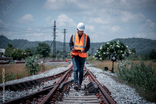 Fototapeta Engineer under  inspection and checking construction process railway switch and checking work on railroad station