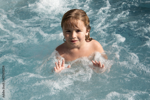 Portrait of little boy swim in sea. Kid laughing in water of waves at sea. Funny kids face.