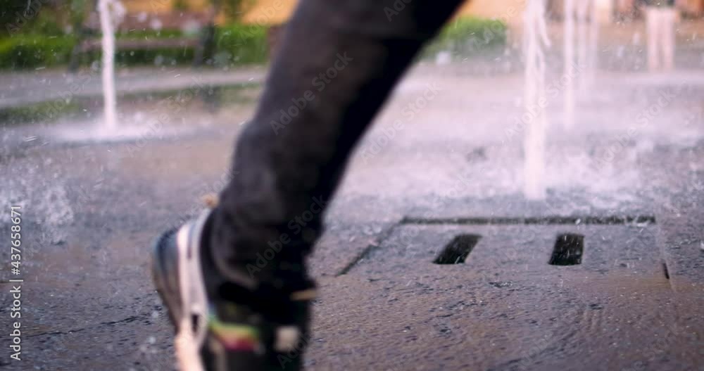 young boy having fun, running through the water fountain in the city park, summer activities young boy having fun, running through the water fountain in the city park, summer activities
