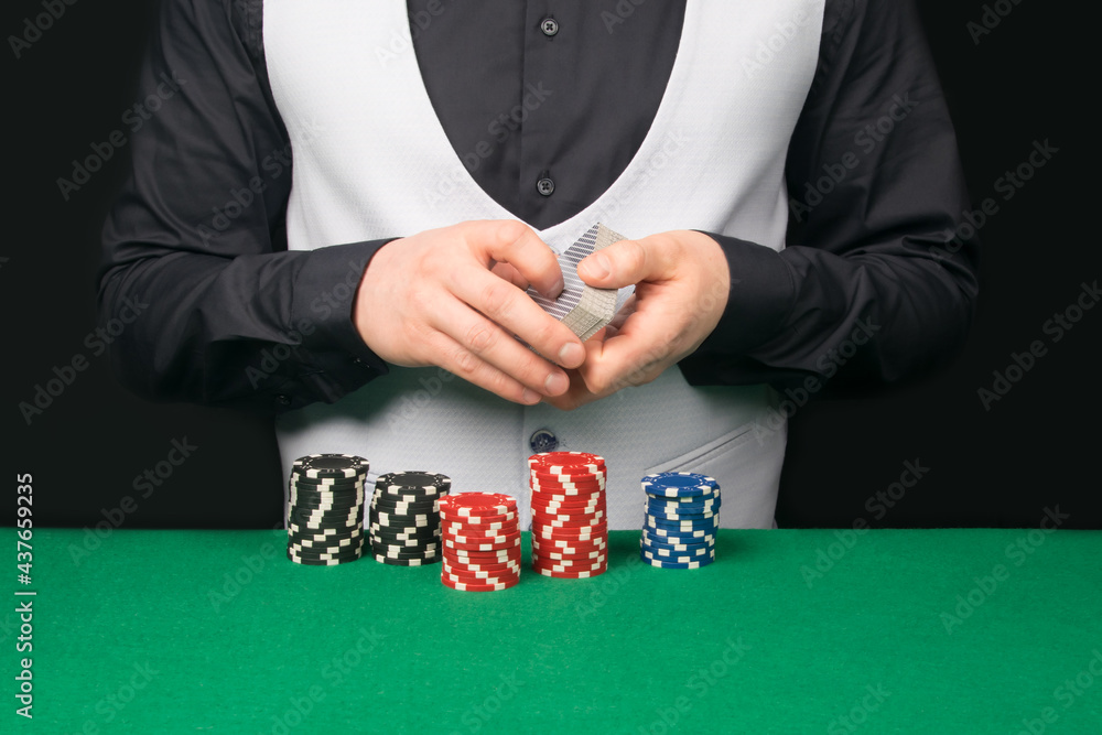 close-up of cards in the hands of the croupier, in the process of mixing and distribution to players at the table close-up of cards in the hands of the croupier, in the process of mixing and distribution to players at the table