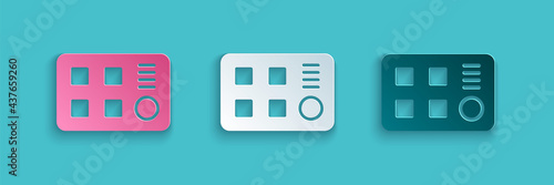 Paper cut Drum machine icon isolated on blue background. Musical equipment. Paper art style. Vector