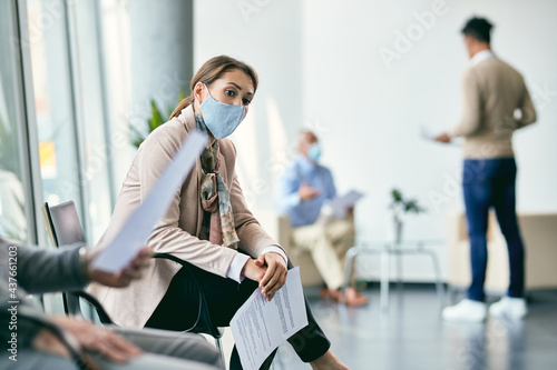 Thoughtful female candidate waiting for job interview during coronavirus pandemic.
