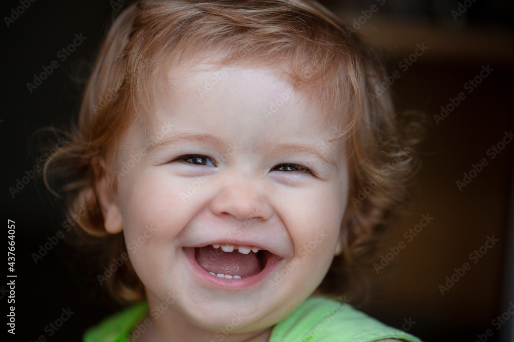 Portrait of a happy laughing child. Smiling infant, cute smile. Close up positive kids baby face. Portrait of a happy laughing child. Smiling infant, cute smile. Close up positive kids baby face.
