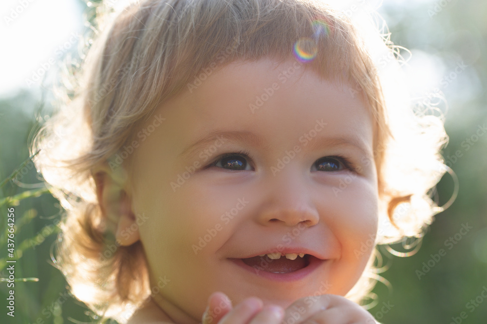 Kids portrait, close up head of cute child. Baby smiling, cute smile on sunny day. Cropped face outdoor. Kids portrait, close up head of cute child. Baby smiling, cute smile on sunny day. Cropped face outdoor.