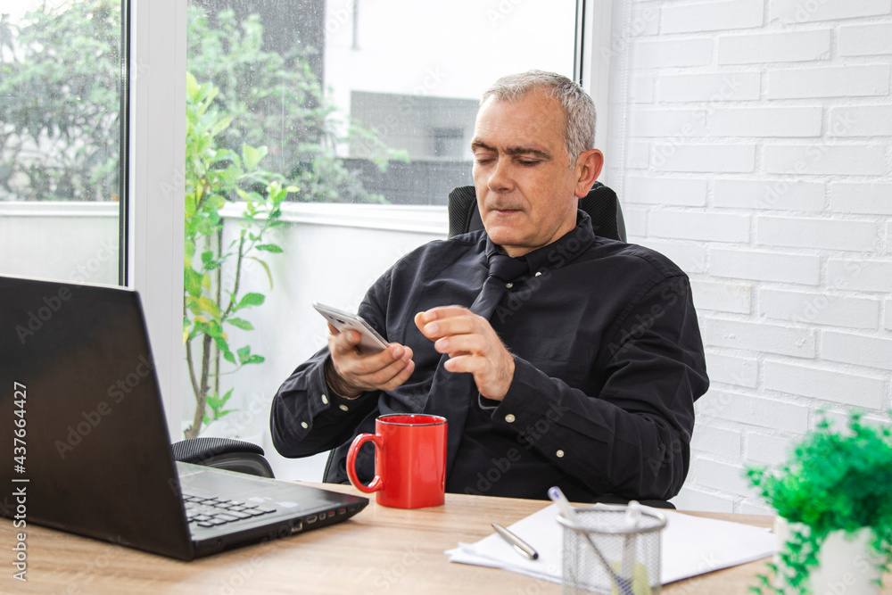 businessman in office talking on the phone businessman in office talking on the phone