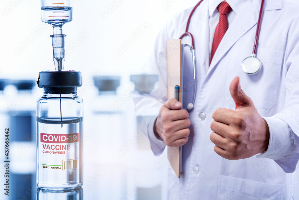 Fototapeta premium Concept fight against virus covid-19 corona virus, doctor with a stethoscope with a bottle of COVID-19 vaccine adults, Concept: diseases, medical care, science. 