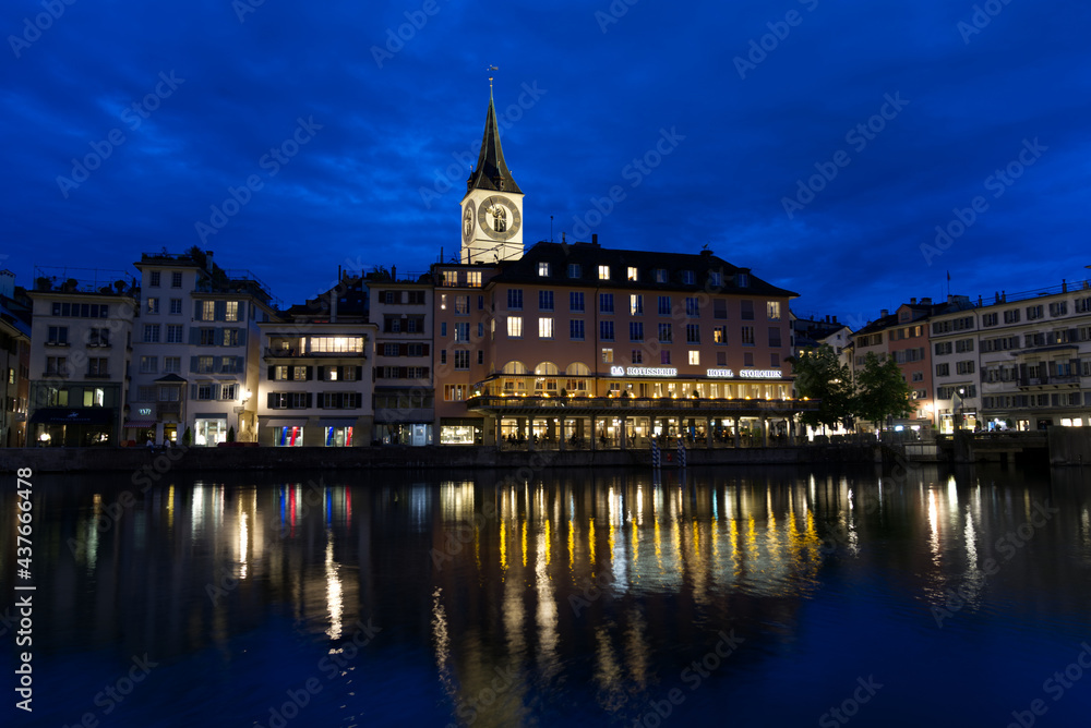 Church St. Peter and Hotel Storchen (hotel stork) at the old town of Zurich at summer night. Photo taken June 5th, 2021, Zurich, Switzerland.