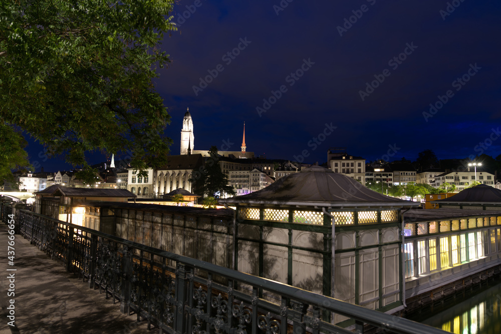 Wooden building women's bath at river Limmat at the old town of Zurich by night at summertime. Photo taken June 5th, 2021, Zurich, Switzerland.